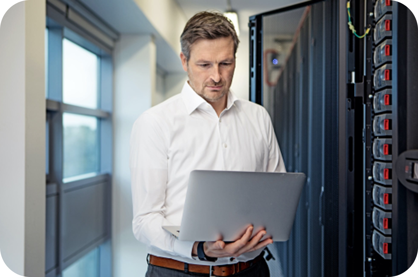 Man with laptop and servers